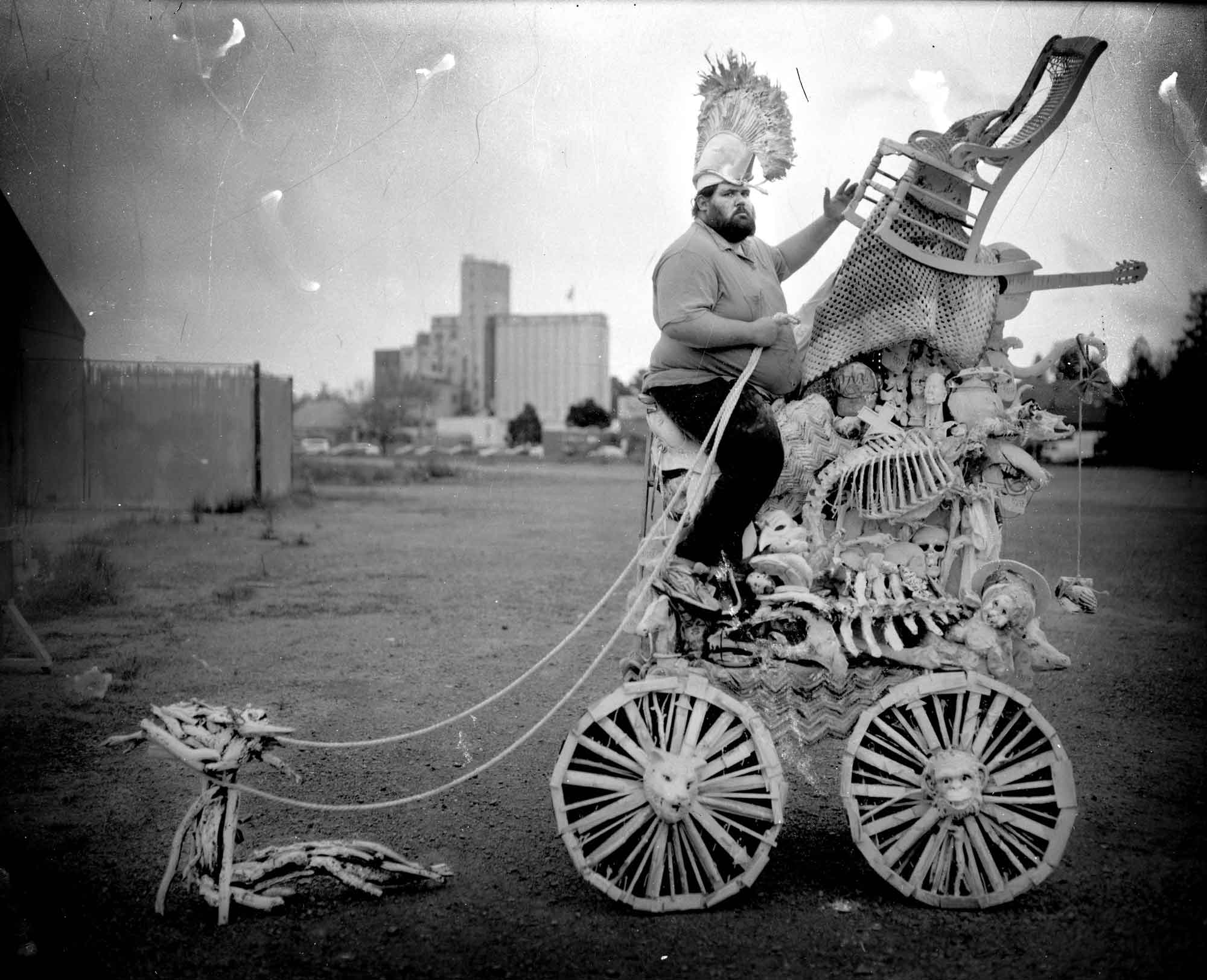 black and white photo of a man on a strange vehicle statue by Michael Garlington