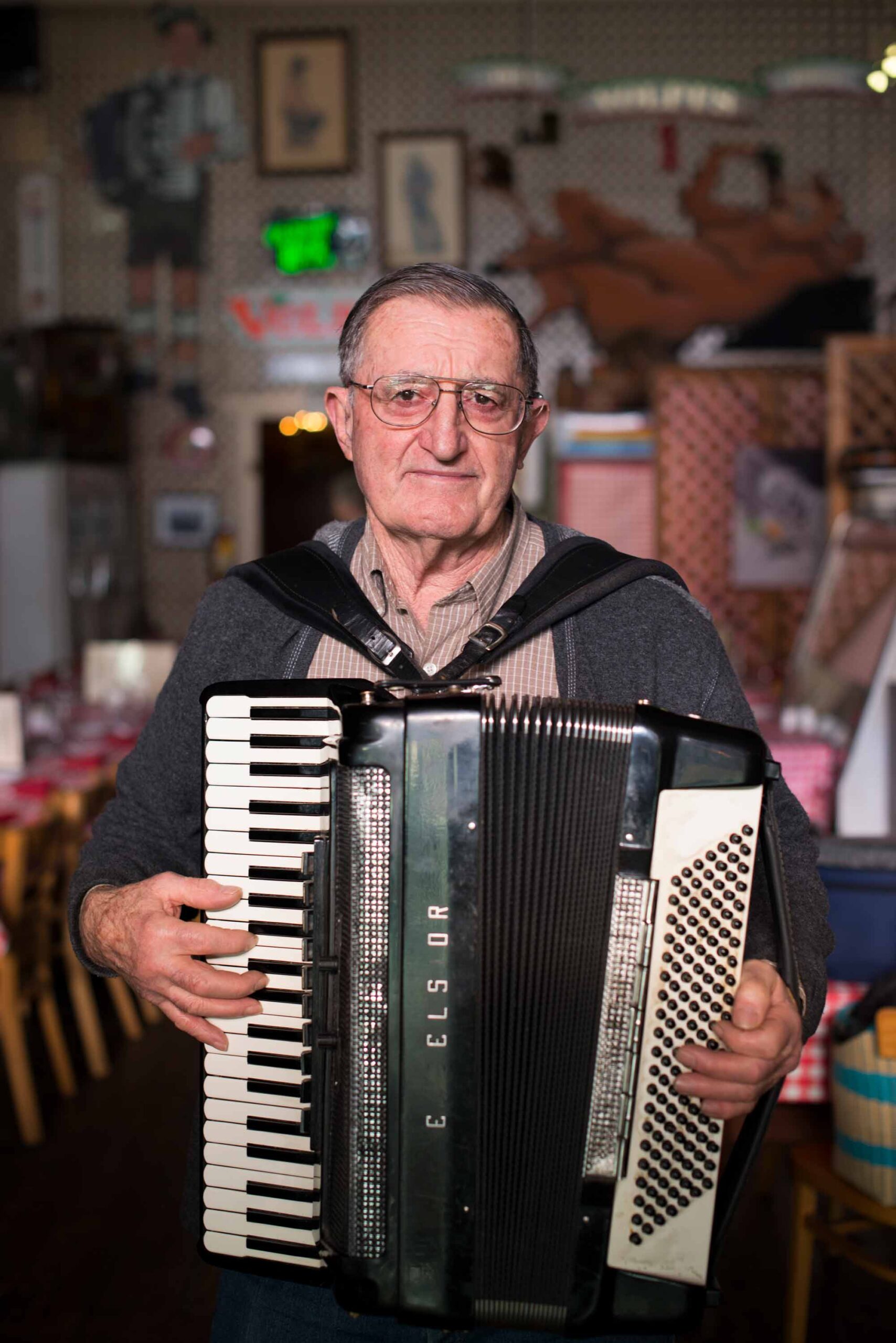 photo of John Volpi holding an accordion by Jude Mooney