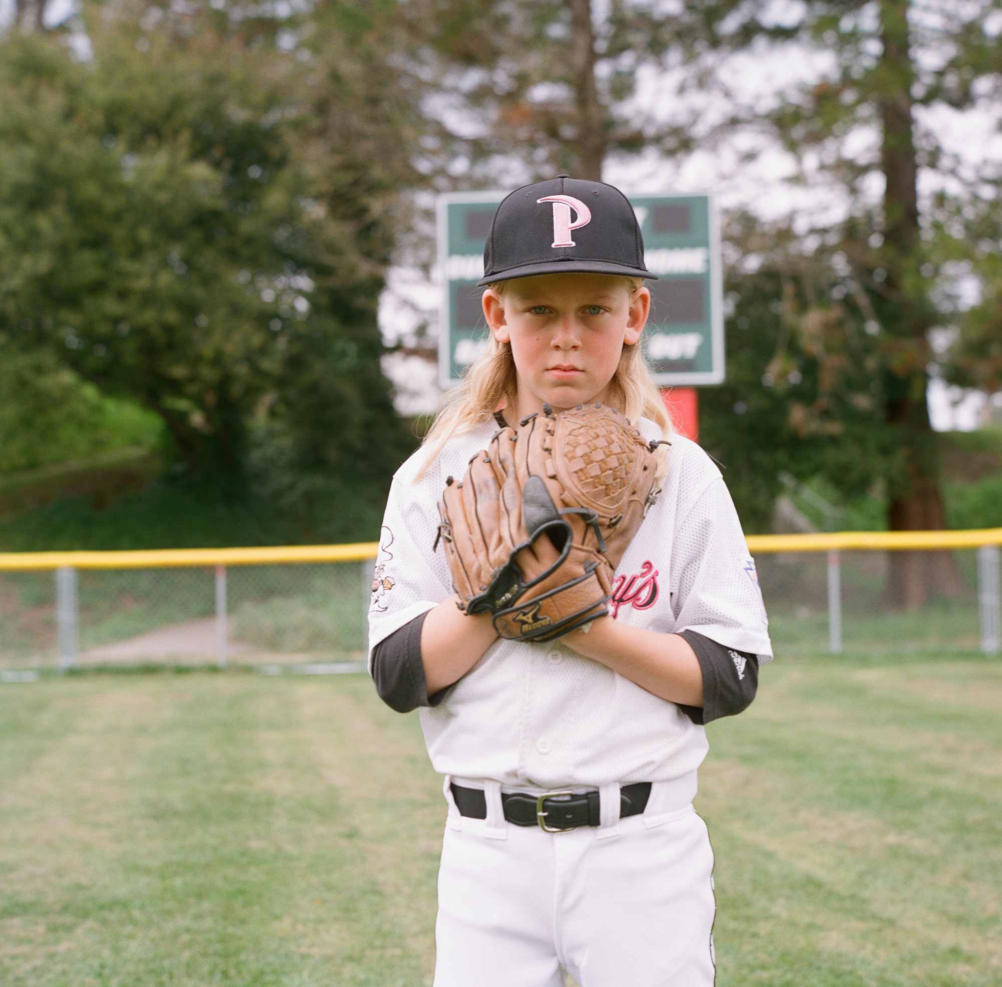 young boy in a baseball uniform - photo by Paige Green